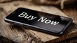 © Anat art - Smartphone Displaying Buy Now Text on Wooden Surface Suggesting Online Shopping on a Rustic Background