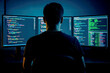 © DailyStock - Senior programmer works late at night on multiple computer screens displaying complex code, focused on software development and troubleshooting tasks