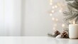 © Iaroslav - Burning candle, pine cones and fir branches creating a christmas atmosphere on a white lights with blurred table