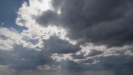 Wall Mural - an aerial 4k time lapse of fluffy storm clouds bathed in sunlight filmed from above like an airplane or drone flight capturing a surreal pearl grey sky after rainfall in crystal clear detail