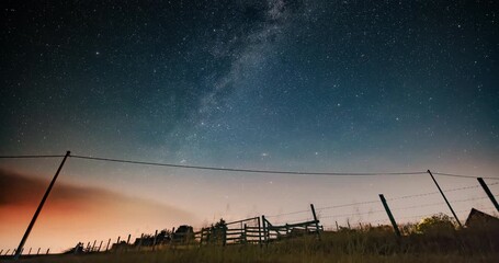 Wall Mural - milky way star-trails and rural countryside tree silhouettes. time-lapse video.