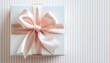 © Hmdx - Elegant White Gift Box with Pink Ribbon on Striped Background
