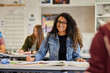 © Rido - Smiling african american student in classroom looking at camera