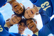 © Rido - Smiling team huddle cheering after victory