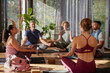 © Rido - Group of multiethnic people meditating in a circle at yoga studio