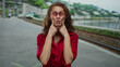 © Krakenimages.com - Young woman with glasses making playful faces at outdoor train station with railway background