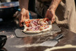 © K - Hands preparing fresh dough with vegetables and toppings in rustic kitchen environment, showing authentic traditional cooking, homemade food preparation and lifestyle culinary experience
