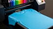 © graphiczone872 - Blue tshirt on a director garment printer