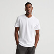 © Mr.Spy - Confident young african american man wearing a blank white t-shirt, standing with hands in pockets against a white background