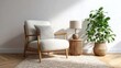 © Shelley - Beige armchair with wooden lamp on jute rug, green plant in woven pot, Scandinavian-inspired modern living room interior.