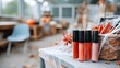 © pvl0707 - Colorful lip glosses arranged on a table with autumn decorations in a cozy indoor market during fall season