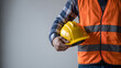 © taswar786 - Professional construction worker holding safety helmet ready for work, showcasing industry expertise and commitment to safety protocols