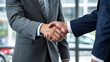 © AimanAsad - Businessmen shake hands, signifying a deal or agreement.