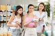© JackF - Attentive mother and daughter buyers choosing medical ointment and professional female parmacist helping in small pharmacy