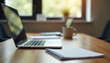 © AlexanderVP - Modern workspace with laptop, coffee cup, and stationery on table