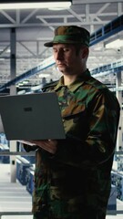 Poster - Vertical video Army soldier in server farm uses artificial intelligence program on laptop to review reconnaissance information. Military data center worker uses deep learning to plan mission, camera A