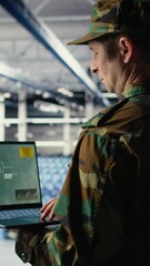 Poster - Vertical video Military technician in data center tracking satellite coordinates using notebook software interface. Army unit in server hub analyzing reconnaissance data through satellite imaging