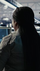 Poster - Vertical video Military staff in server room uses AI tools to help manage computer systems. Army team wearing uniform reviews information using artificial intelligence programs in server farm, camera
