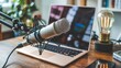 © Pixels Stock - Professional condenser microphone set up for podcasting or recording audio with a laptop and vintage edison bulb in a home studio