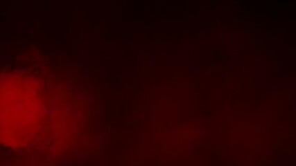 Wall Mural - thick, dense red smoke or fog billows and flows from the left across a black background. atmospheric