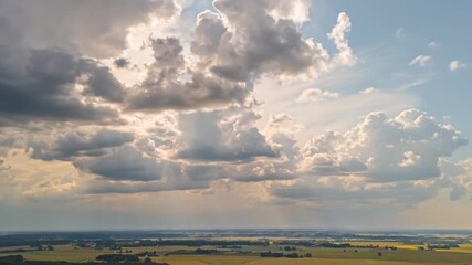 Wall Mural - Timelapse of dramatic clouds over vast countryside landscape