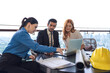 © Jack Tamrong - Male Indian real estate project manager working and brainstorming with female architect teammates