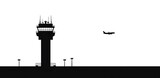 Black silhouette of an airport control tower with a jet airplane flying image