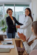 © bernardbodo - Businesswoman shaking hand with female doctor after presentation