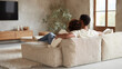 © SolaruS - Cozy couple relaxing at home on a comfortable couch. A loving and peaceful domestic scene, perfect for illustrating relationships, downtime, and modern living.