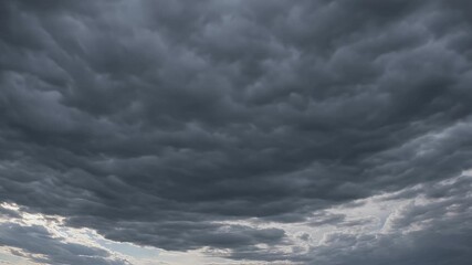 Wall Mural - moody time lapse thick clouds slowly spreading sky covering sunlight shifting atmosphere calm rainy day tone perfect 4K nature background storytelling