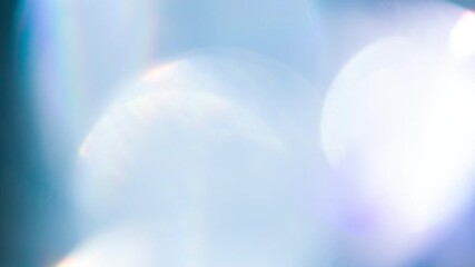 Wall Mural - Flowing Bokeh of Sun Glare. Loop. The light passes through the facets of a slowly rotating diamond and creates repetitive sparkling highlights and rainbow colors