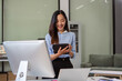 © NINENII - Businesswomen hand working with tablet and laptop computer with documents on office desk in modern office.