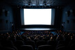 © serperm73 - Full cinema audience watches attentively as the projector beam hits the empty screen.