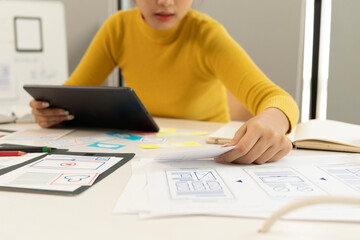 Wall Mural - Creative web designer planning UI application and developing digital template