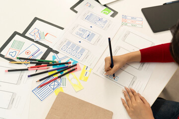 Wall Mural - Creative web designer planning UI application and developing digital template