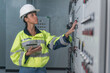 © ENGINEER - STUDIO - electrician working in a factory. electrician at work. electrician working in a power station. engineer working on the checking status switchgear electrical energy distribution substation.