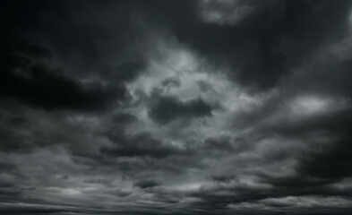 Wall Mural - dark dramatic sky with black stormy clouds before rain as abstract background, extreme weather
