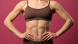 © Camel Studio - Fit female body in brown sports attire, highlighting toned abs and strong arms on magenta.