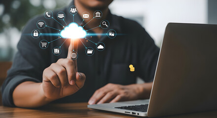 Poster - Man Using Laptop Surrounded by Cloud Computing Icons Data Connection Concept In Bright Light With Wooden Table In