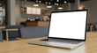 © abu - Silver Laptop with Blank White Screen on Wooden Table in Bright Cafe Environment
