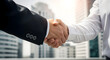 © abu - Successful Businessmen Handshake In Front of Modern Office Building symbolizing partnership success in formal attire on