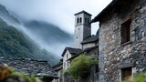 A mountain range with foggy weather and a stone building with a tower
