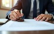 © nian - Man stamping approval on financial, banking, or investment documents at his desk official paperwork. rubber stamp with contract law and business documentation for legal agreements financial.