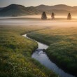 © Jo - Serene Morning Mist Gently Flows Through a Lush Green Meadow with a Winding Stream Under Golden Sunrise Light