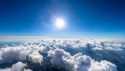 Wall Mural - high altitude view of fluffy clouds and a bright sunny sky a vast expanse of cumulus clouds fills the entire scene with a vibrant blue sky and a bright sun land is visible beneath the clouds