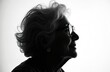 © miss irine - Profile silhouette of senior woman face with glasses, grey-haired. Her expression is calm and intelligent. Focus on mature, wise, confident lady, white background. Elegant and sophisticated portrait.