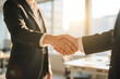 © E V A N   Studios - Close-up of business handshake in modern office