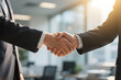© E V A N   Studios - Close-up of business handshake in modern office