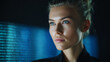 © venusvi - A focused individual with striking features gazes thoughtfully into the distance, illuminated by a soft blue light.