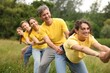 © New Africa - Team building. Group of happy people holding hands outdoors